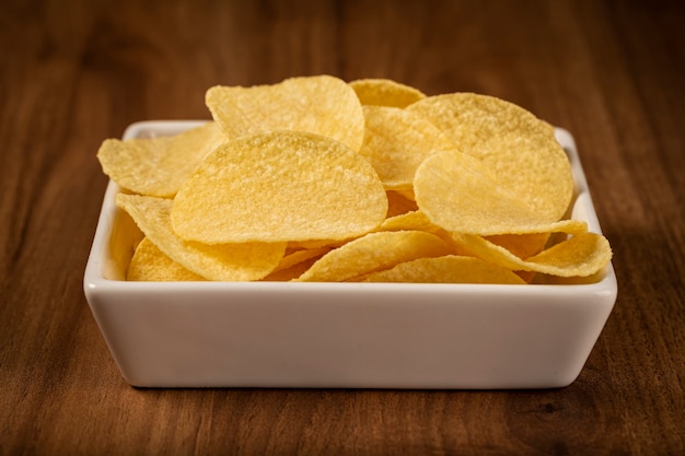 Delicious crispy potato chips on the table