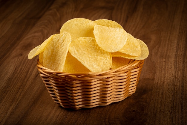 Delicious crispy potato chips on the table