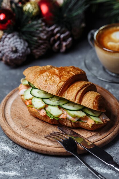 Delicious croissant with shrimp and cucumber