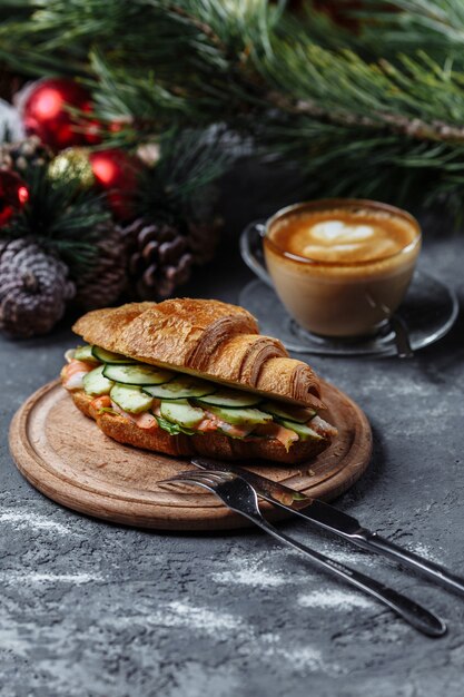 Delicious croissant with shrimp and cucumber