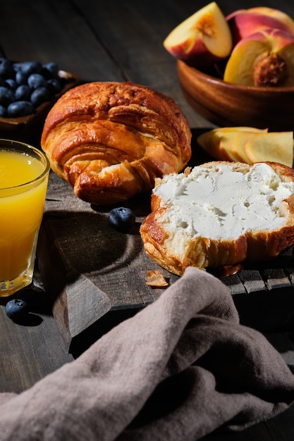 Delicious croissants for breakfast. Fresh homemade cakes with berries, jam, cream cheese and fruit.