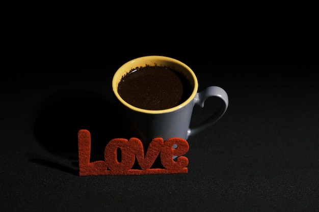 Delicious cup of coffee and red love lettering