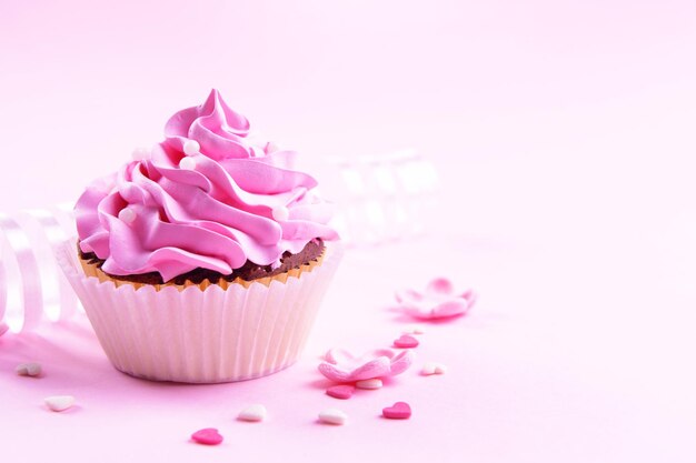 Delicious cupcake on pink background