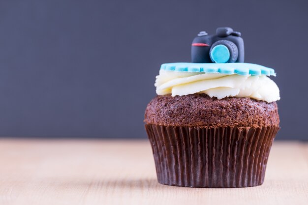 Delicious cupcake on table