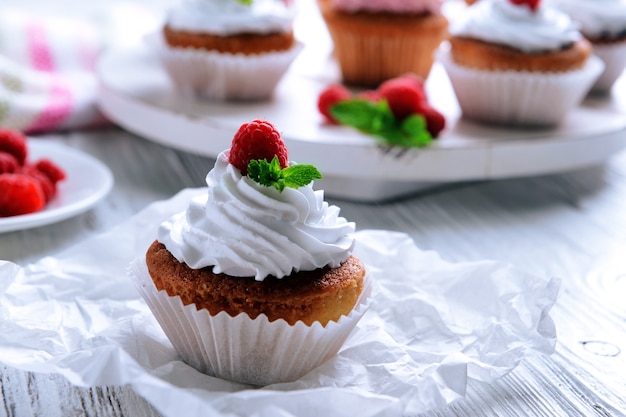 Delicious cupcake with berries on table close up