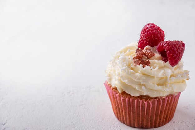 Delicious cupcake with raspberry.