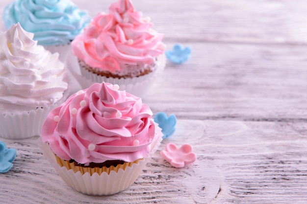 Delicious cupcakes on table closeup