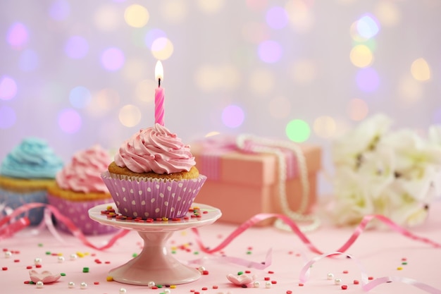 Delicious cupcakes on table on light background