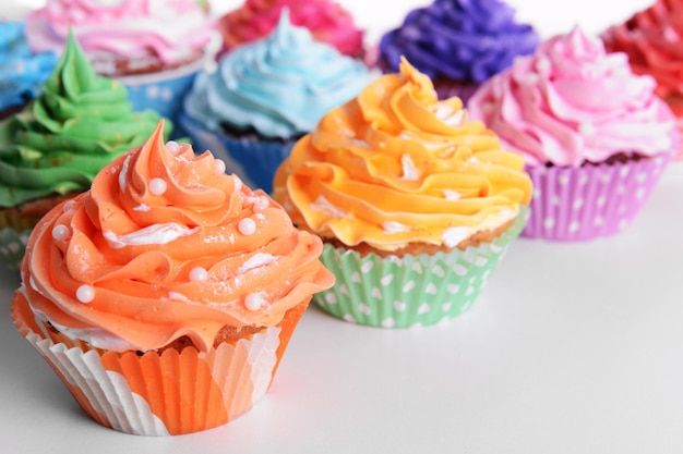 Delicious cupcakes on white background