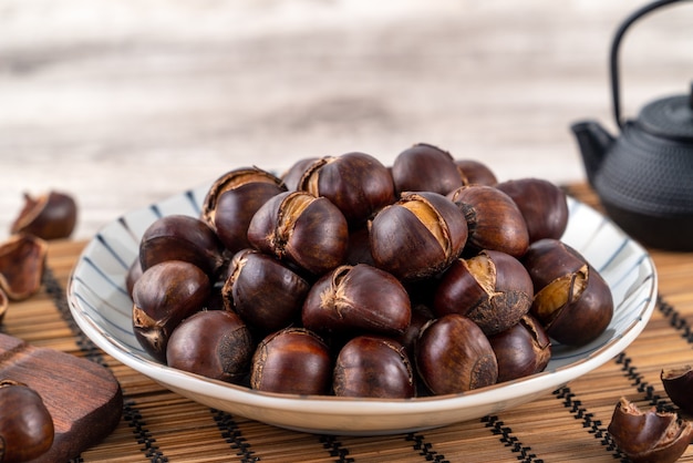 delicious cut roasted chestnuts with oil and sugar, healthy eating snack in life, close up.