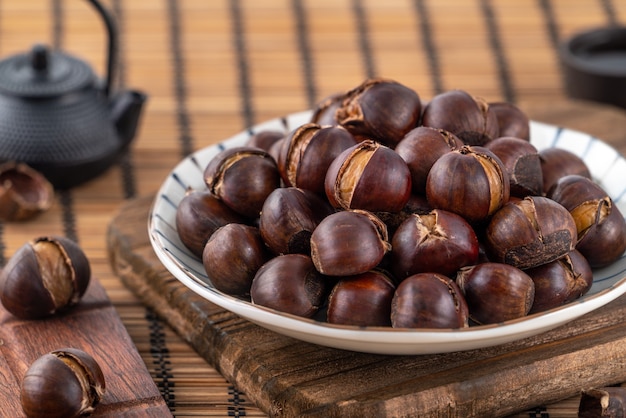 Delicious cut roasted chestnuts with oil and sugar, healthy eating snack in life, close up.