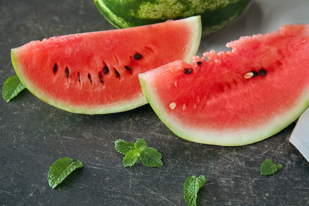 Delicious cut watermelon on dark table