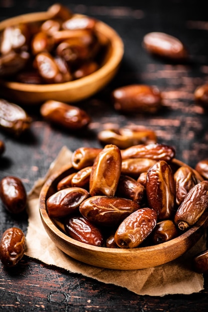 Delicious dates on a wooden plate