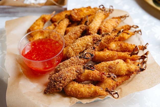 Delicious deep fried prawns and chicken strips on skewers served with sweet chili sauce