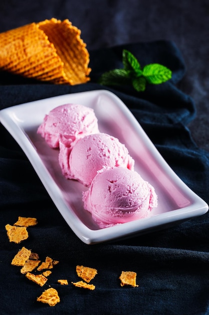 Delicious dessert on black background Strawberry ice cream