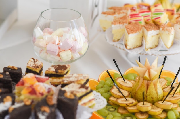 Delicious desserts on buffet table at the wedding