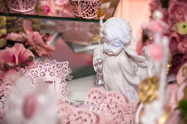 Delicious desserts at the wedding candy bar in the buffet area: statuette, figurine, angels