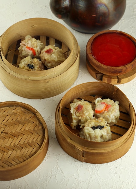 Delicious Dim Sum in bamboo steamer on the Table Tasty Chinese Food selective focus