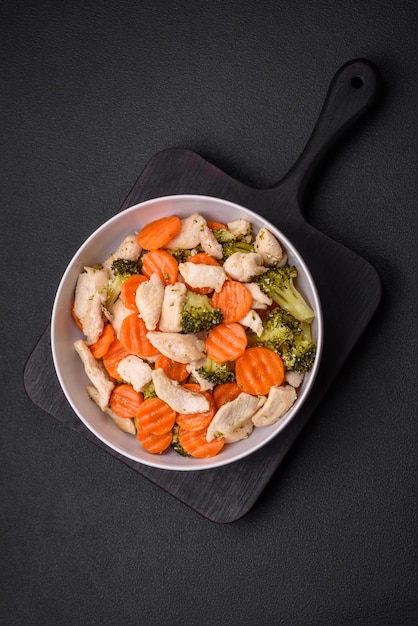 Delicious dish consisting of pieces of boiled chicken broccoli and carrots