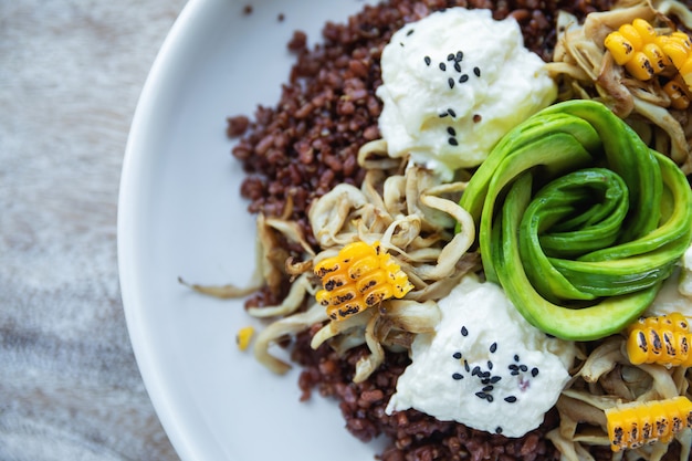 Delicious dish with Avocado, cheese, corn and sprouted wheat grains.