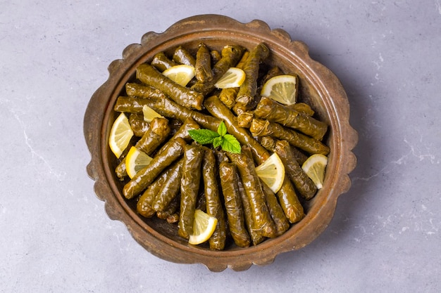 Delicious dolma (sarma) stuffed grape leaves rice. Lebanese dolma sarma on plate. Lebanon turkish greek middle eastern cuisine. (Turkish name; Yaprak sarma)