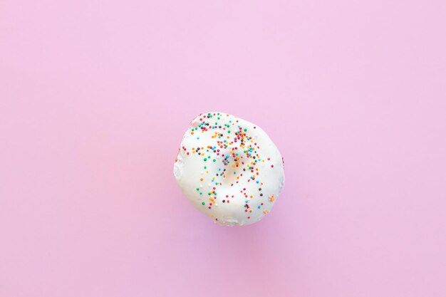 Delicious donut on color pink background