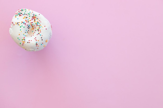 Delicious donut on color pink background