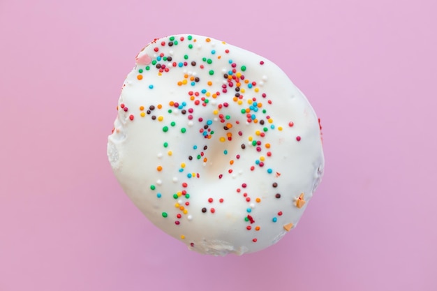 Delicious donut on color pink background