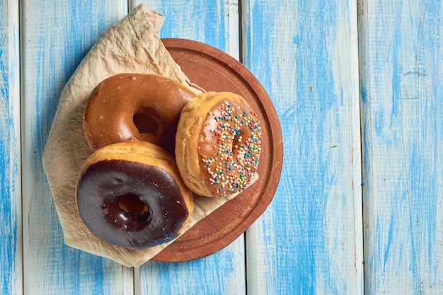 Delicious donuts in rustic background variety of flavors