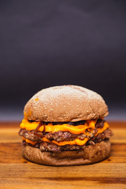 Delicious double beef burger with cheddar cheese and\
caramelized onions beef burger australian bread