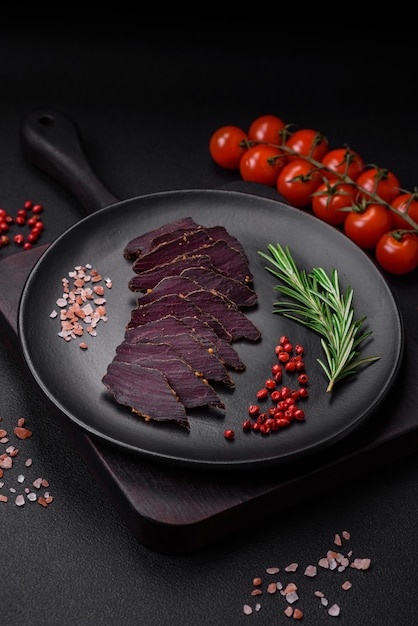 Delicious dried smoked beef or horse meat jerky with spices and salt