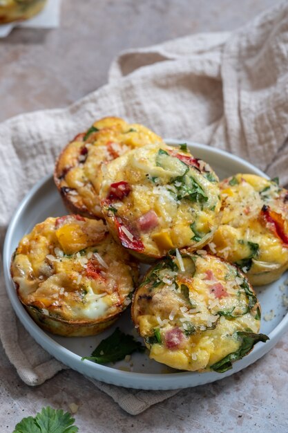 Delicious egg muffins with ham, cheese, spinach and vegetables