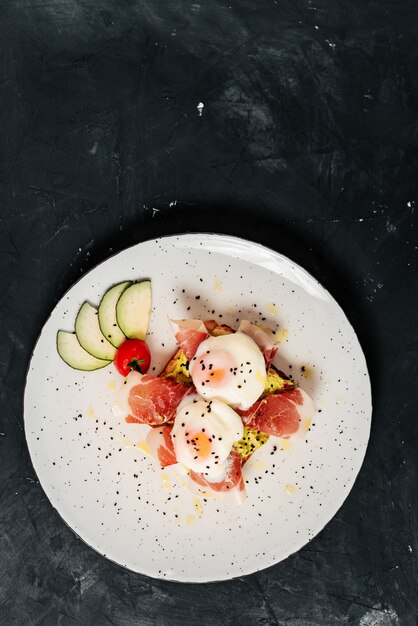 Delicious eggs and ham on a plate. Top view.