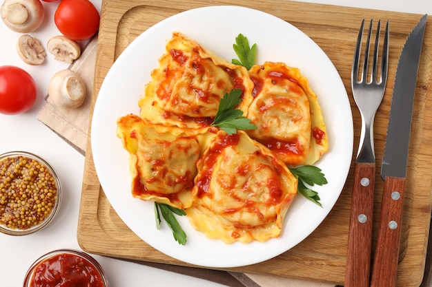 Delicious food concept with ravioli on white background