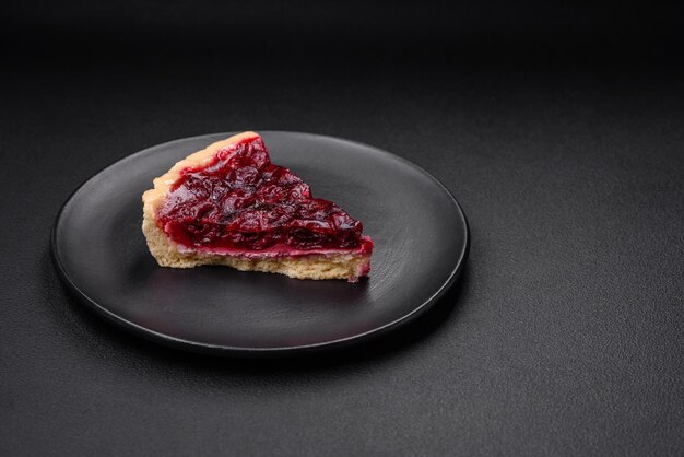 Delicious fragrant sweet pie with cherry berries on a ceramic plate