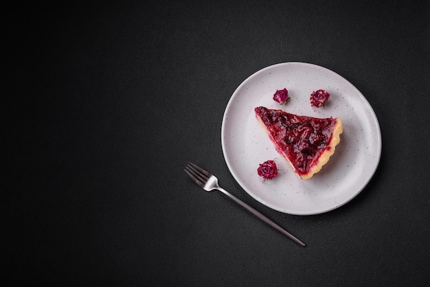 Delicious fragrant sweet pie with cherry berries on a ceramic plate