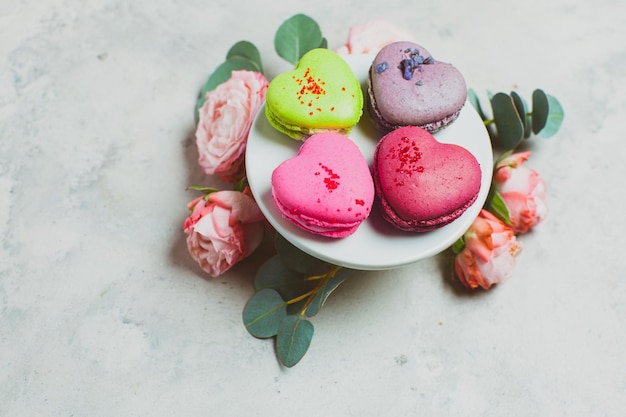 Delicious french dessert with a bouquet of beautiful roses