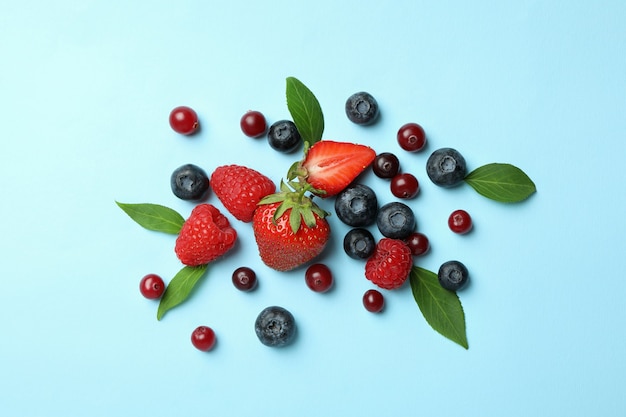 Delicious fresh berry mix on blue