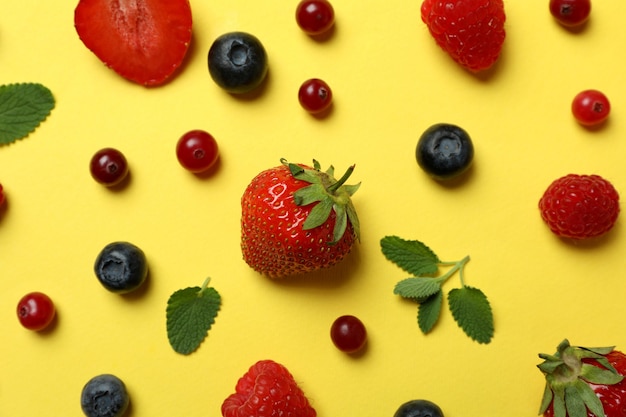 Delicious fresh berry mix on yellow