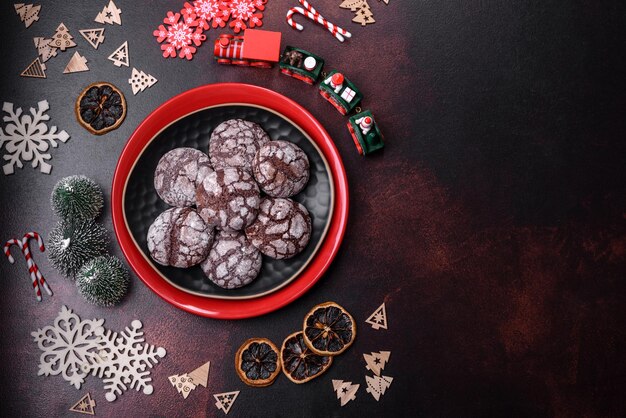 Delicious fresh brownies with Christmas decorations on a dark concrete background