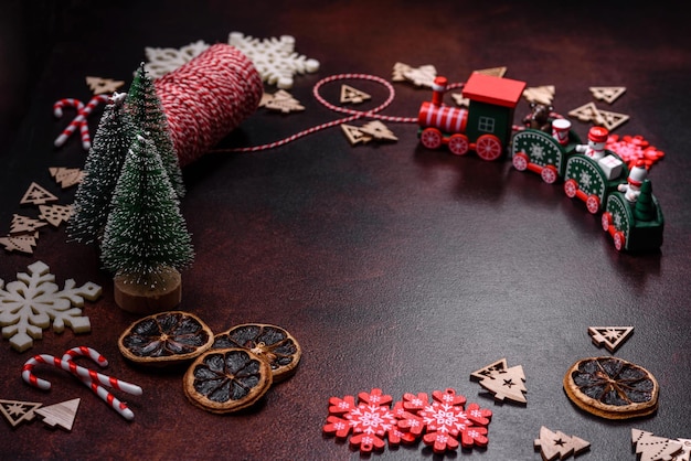 Delicious fresh brownies with Christmas decorations on a dark concrete background