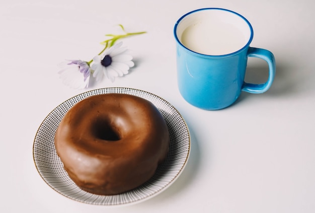 Delicious fresh chocolate donut on white background Appetizing tasty glazed donut ready to eat