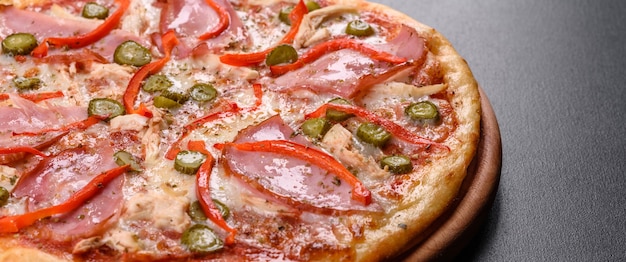 Delicious fresh crispy pizza from the oven with ham and Bulgarian pepper. Italian cuisine