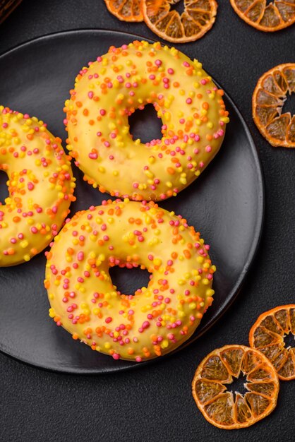 Delicious fresh donuts in yellow glaze with lemon flavor filling