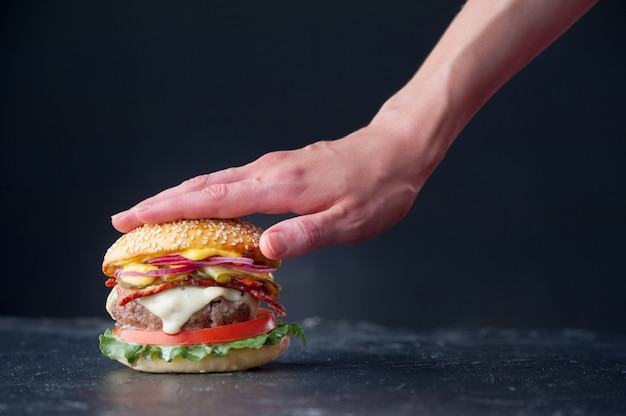 Delicious fresh homemade burger in hands