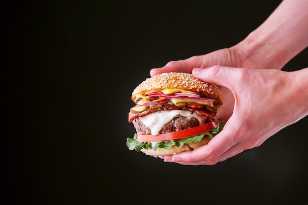 Delicious fresh homemade burger in hands