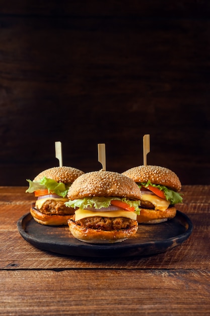 Delicious fresh homemade burger on wooden plate