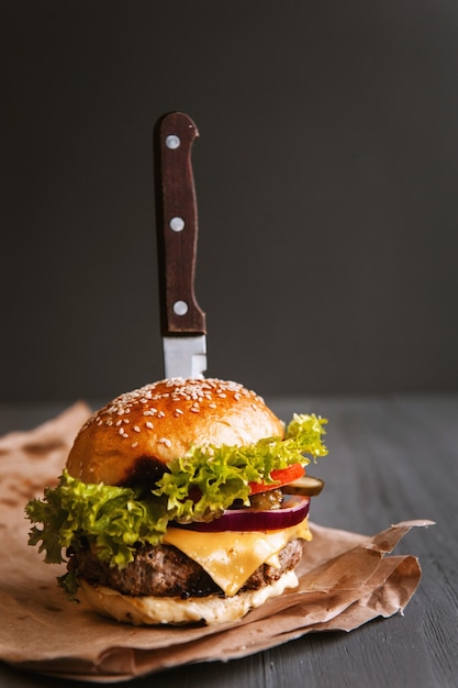 Delicious fresh homemade burger on a wooden table