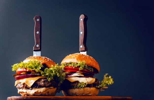 Delicious fresh homemade burgers on a wooden table