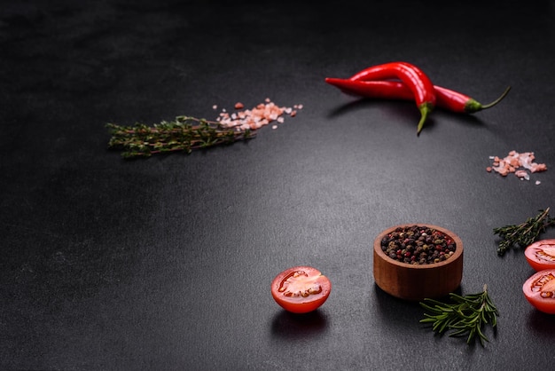 Delicious fresh juicy beef steak with spices and herbs on a dark concrete background